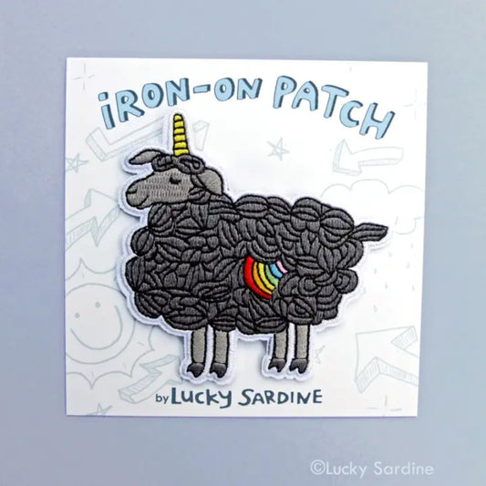 Black sheep iron-on fabric patch with a unicorn horn and a rainbow spot