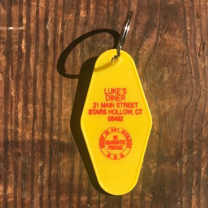 Yellow keychain tag with name and address for Luke's Diner