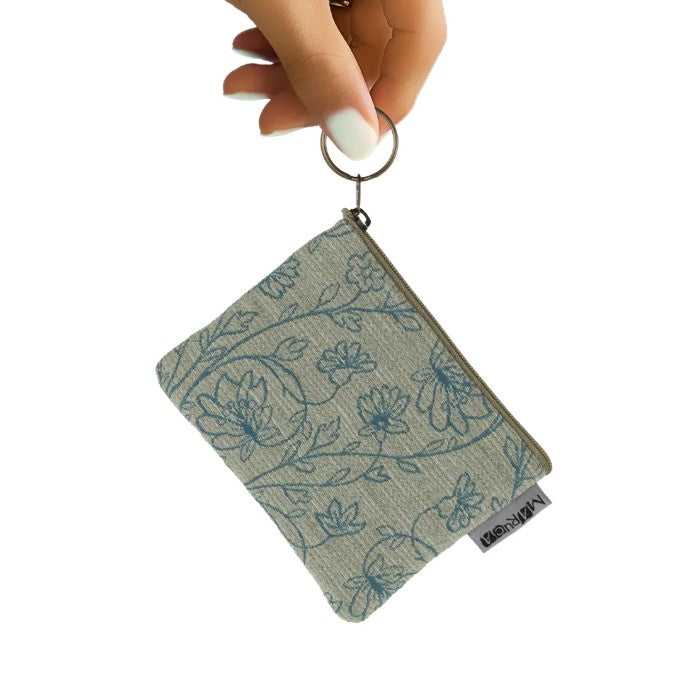Coin purse with a delicate beige and teal floral pattern