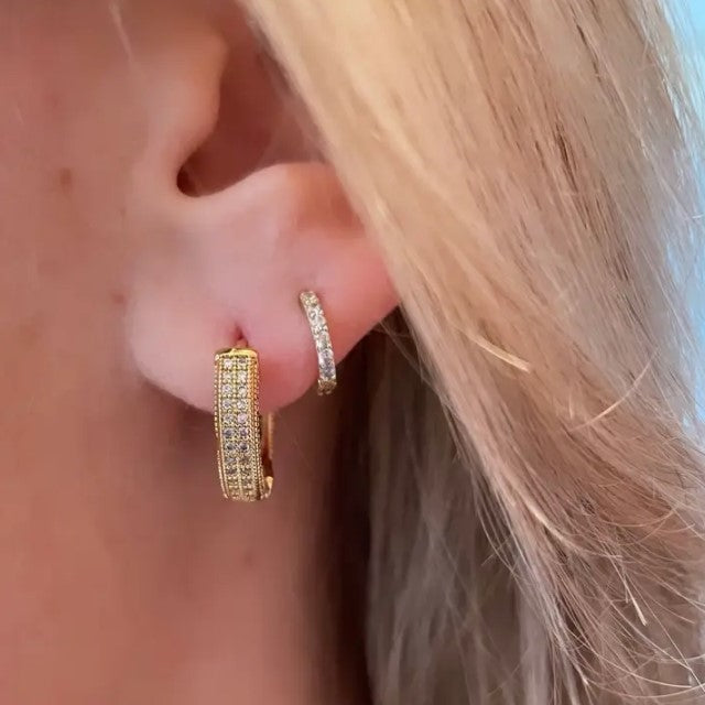 Small gold hoop earrings studded with gems