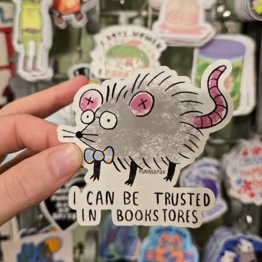 Sticker of a cartoon mouse in glasses and a polka dot bowtie with the caption "I can be trusted in bookstores"