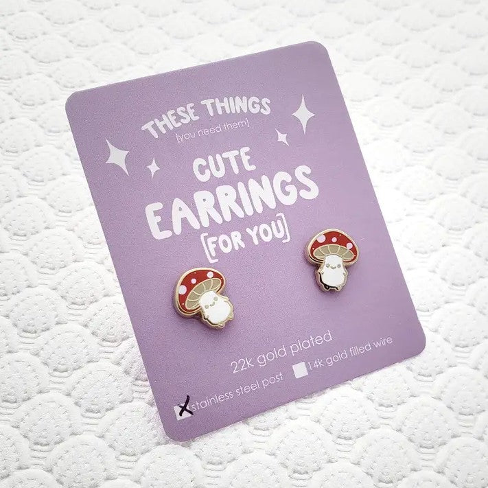 Stud earrings shaped like smiling little mushrooms