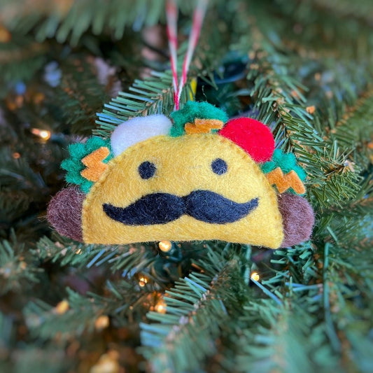 mustache taco ornament in front of christmas tree