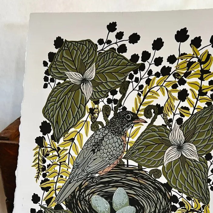 Closeup of a print of a robin perched on the edge of its nest surrounded by sketchy green and yellow foliage.