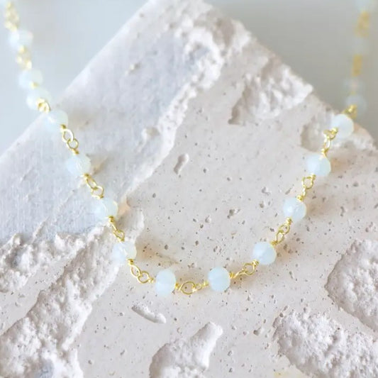 Gold chain necklace with small white opalite beads
