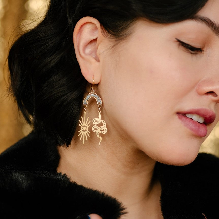 model wearing ophidian earrings