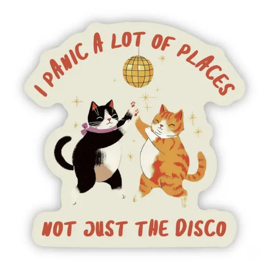Sticker with two cats dancing under a disco ball and the caption "I panic a lot of places, not just the disco"