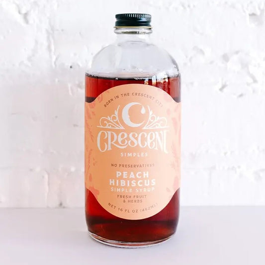 Sixteen fluid ounce bottle of peach hibiscus simple syrup