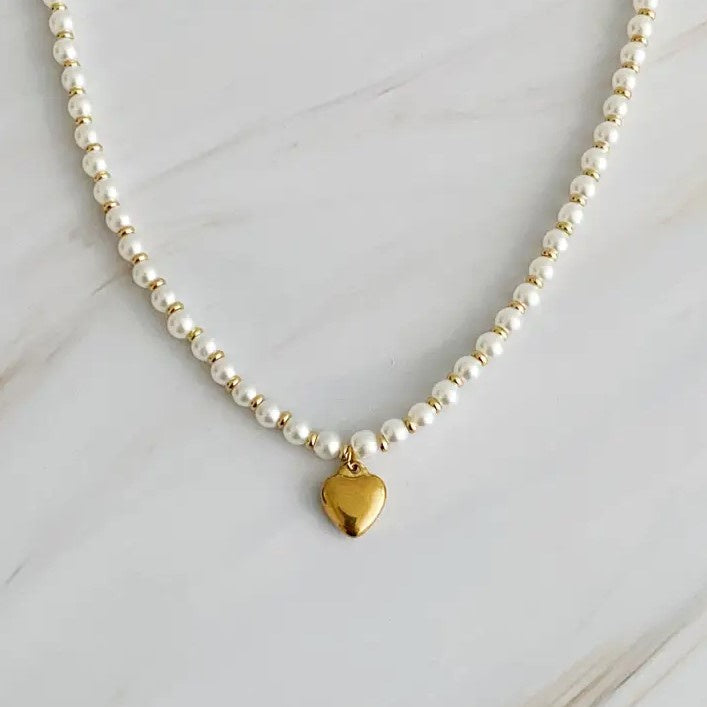 Pearl bead necklace with a heart shaped gold charm as a pendant