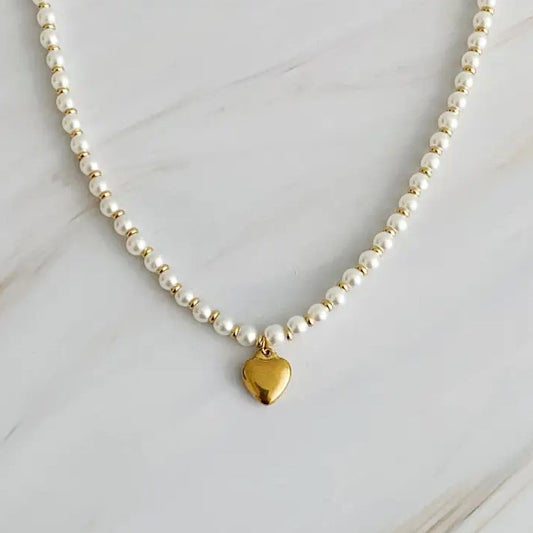 Pearl bead necklace with a heart shaped gold charm as a pendant