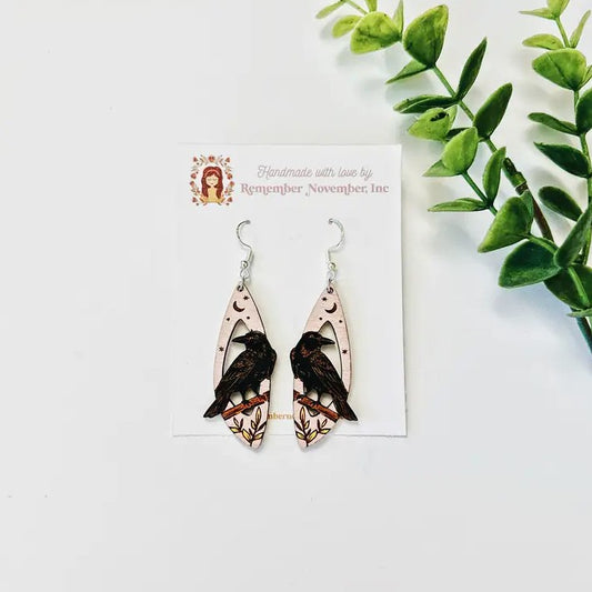 Wooden cutout earrings depicting ravens