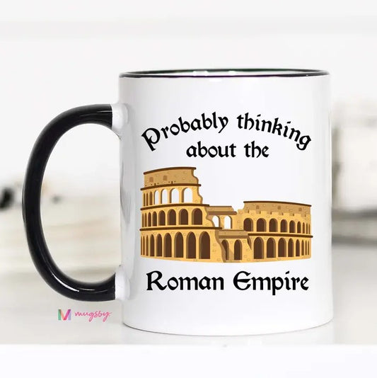 A white mug with an illustration of a colosseum and the caption "Probably thinking about the Roman Empire."