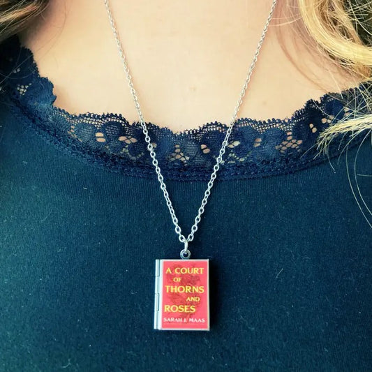 Locket with a red pendant shaped like the book "A Court of Thorns and Roses"