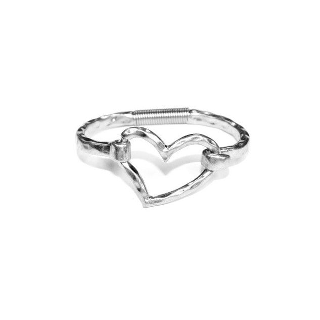 Silver cuff bracelet with an asymmetrical heart at the center
