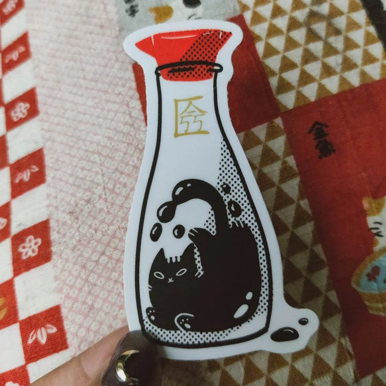 Sticker of a soy sauce dispenser with a black cat inside of it