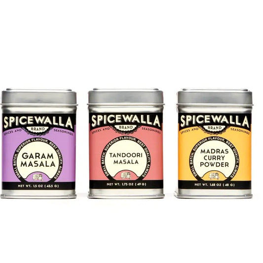 Three Spicewalla spice tins labeled 'Garam Masala', 'Tandoori Masala', and 'Madras Curry Powder' on a white background.