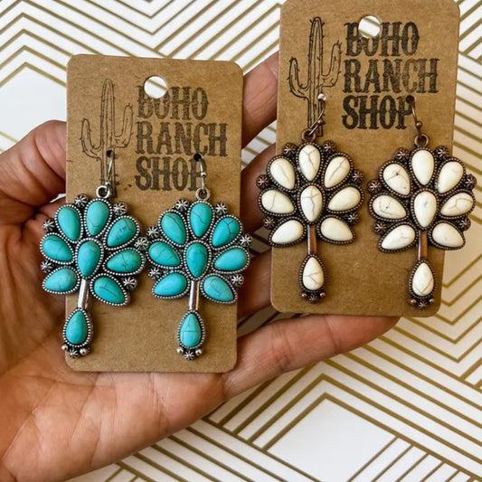Earrings available with turquoise or white stones in the shapes of flowers