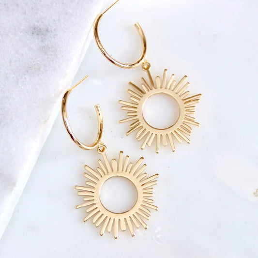 Small gold hoop earrings with dangling suns