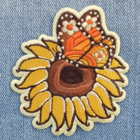 Iron-on fabric patch depicting a monarch butterfly on a sunflower