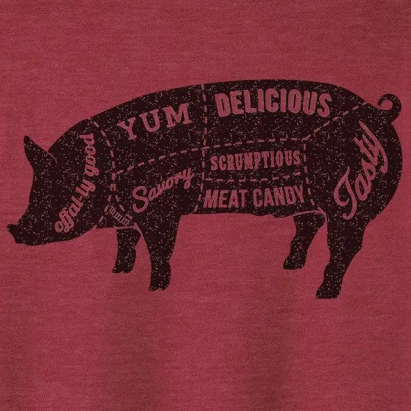 Closeup of an illustration on the front of a red tee shirt depicting a pig silhouette sectioned into "yum," "savory," "meat candy" etc.