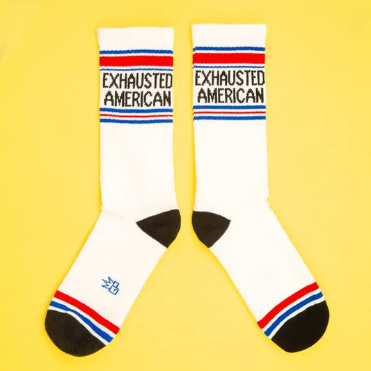 White calf socks with red and blue stripes and the words "exhausted American" on them