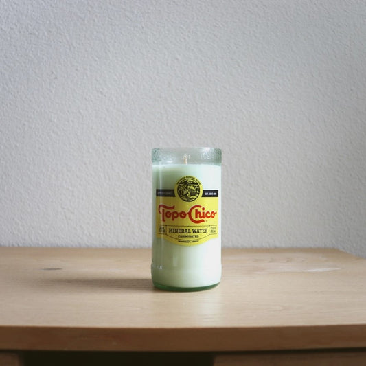 Candle in a repurposed Topo Chico bottle