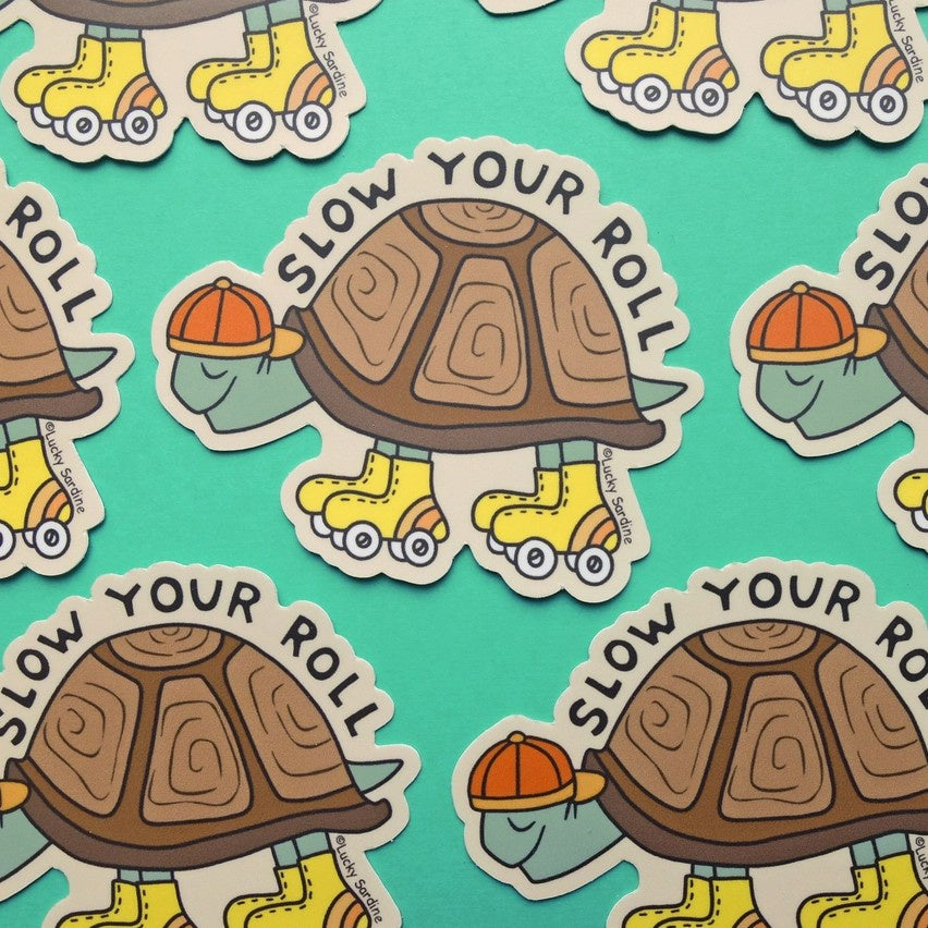 Sticker of a turtle with yellow roller skates and the words "slow your roll"