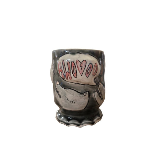 Dark gray ceramic cup with wolf heads howling "awooo" etched on the side