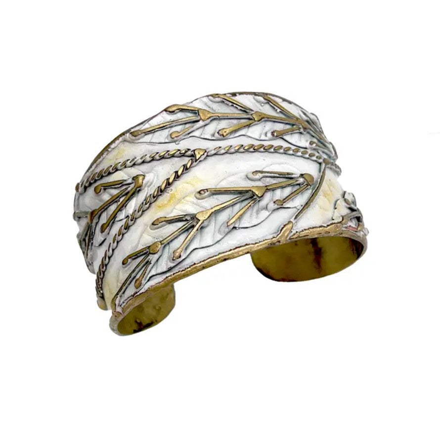 White cuff bracelet with gold accents shaped like leaves