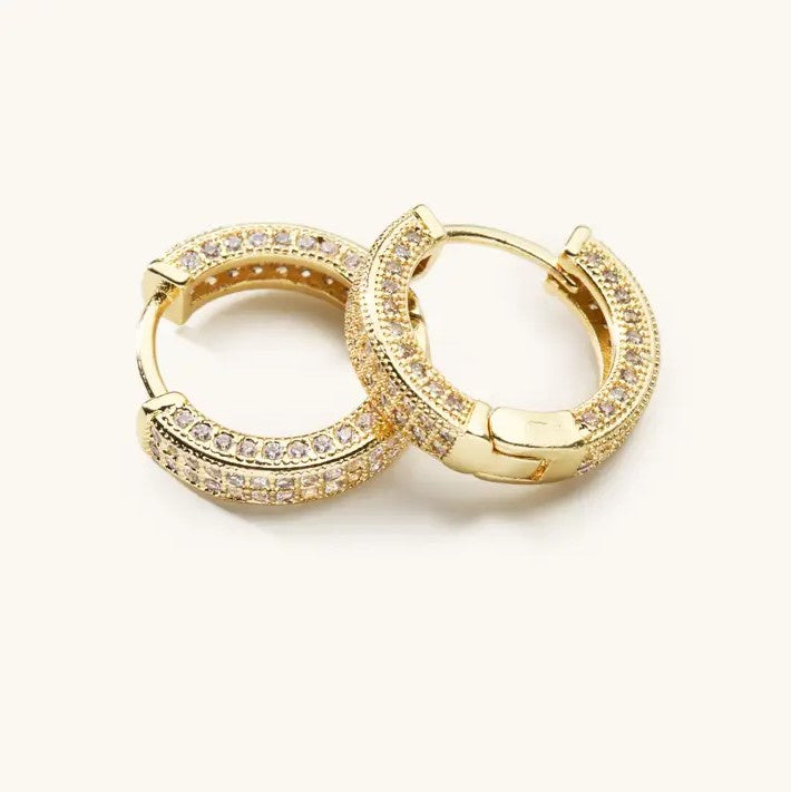 Small gold hoop earrings studded with gems