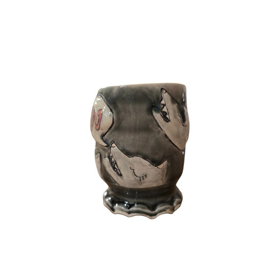 Dark gray ceramic cup with wolf heads howling "awoo" etched on the side