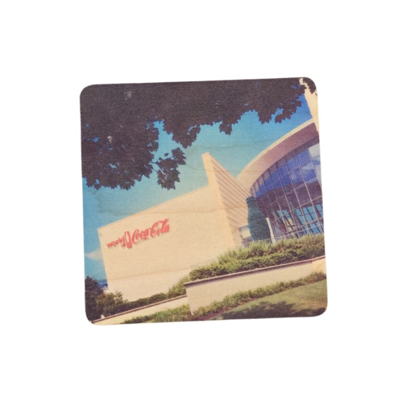Square wooden coaster with a photo of the World of Coca Cola printed on the front