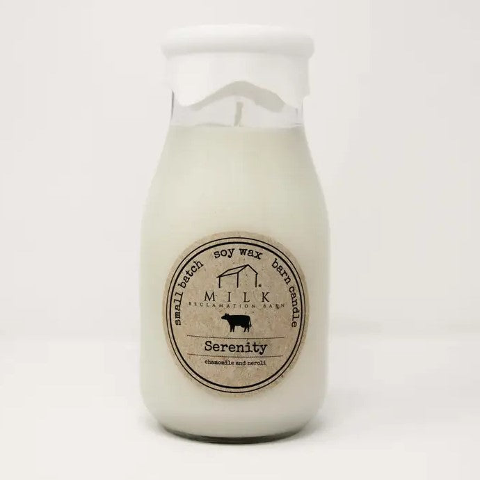 Milk bottle with a candle inside and a milk rubber covering