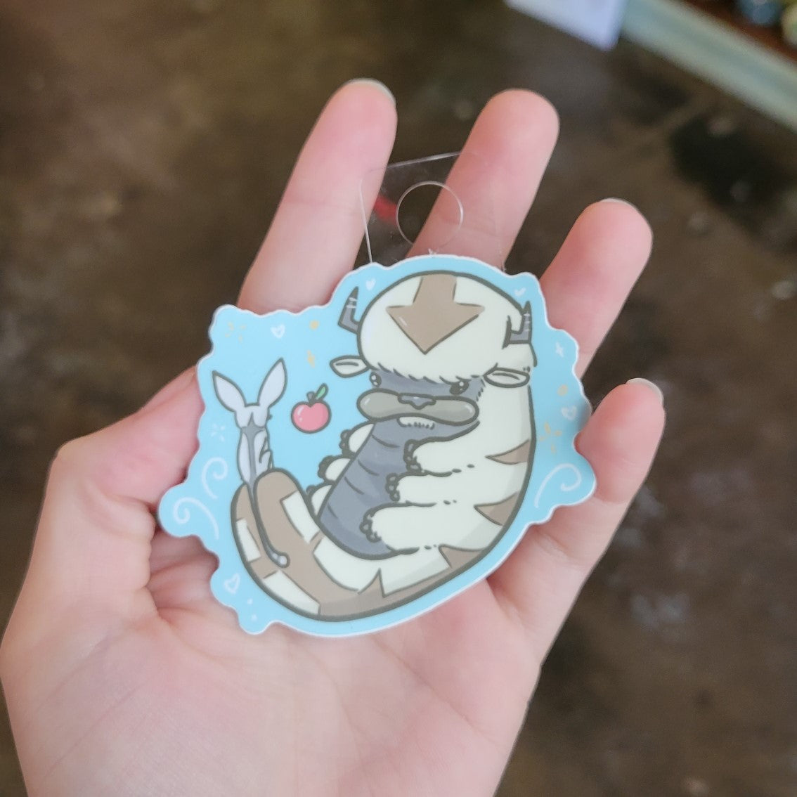 Hand holding Appa Sticker