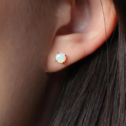 Model wearing simple opal stud earrings