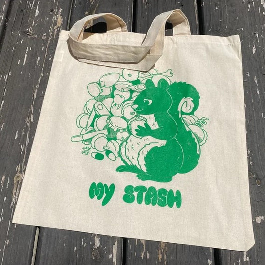Tote with artwork by Tara Sullivan showing a squirrel holding acorn and the text my stash