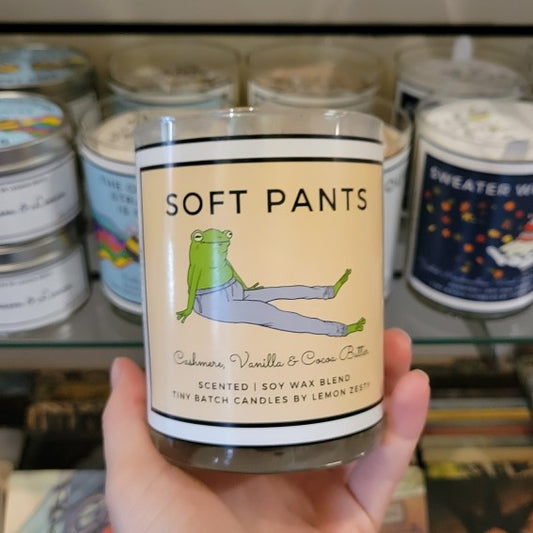 Hand holding candle featuring original artwork by lemon zesty of a frog wearing pants