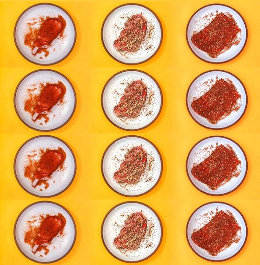 Multiple plates of meat with seasonings