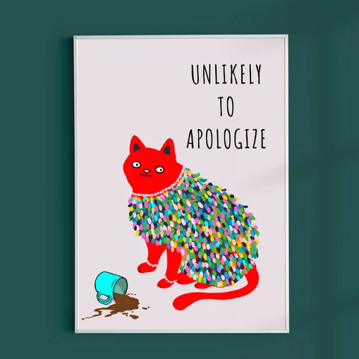 Red Cat with colorful clothes knocking over a cup of coffee