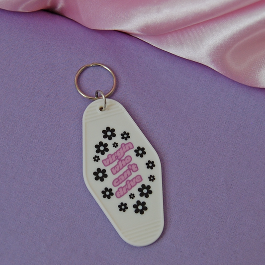 purple text with black flowers quote from the movie clueless on a keychain