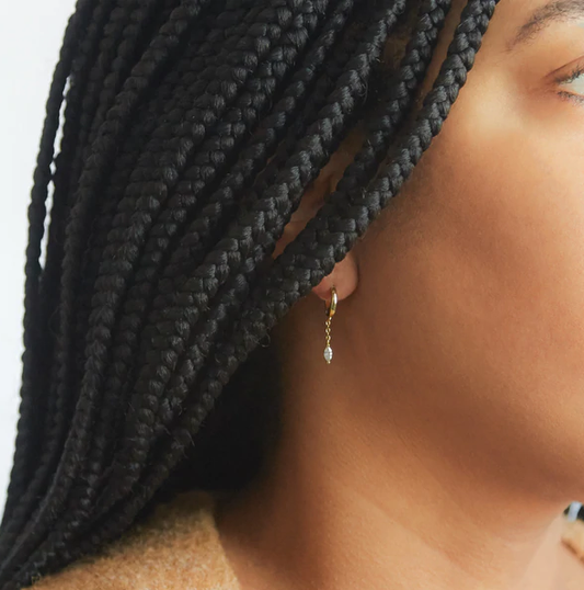 Model showing off white chain huggies