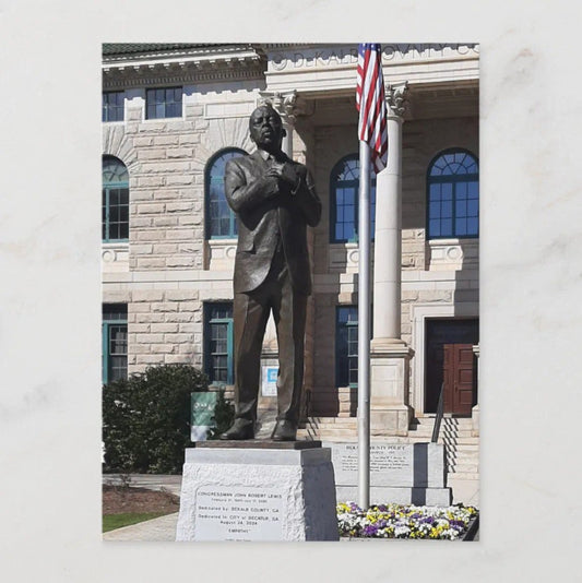 Photo of John Lewis' memorial statue, a man standing with hands clasped over his heart