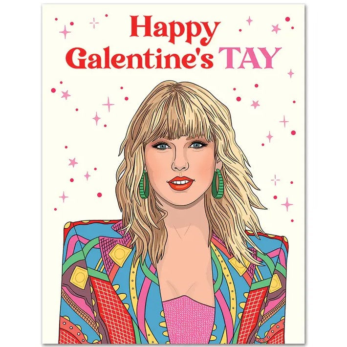 a card featuring an illustration of taylor swift surrounded by pink sparkles on a cream background and captioned "happy Galentine's TAY"