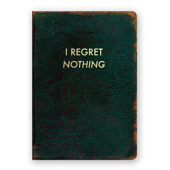 Dark green notebook with leather pattern and gold text that reads "I regret nothing"