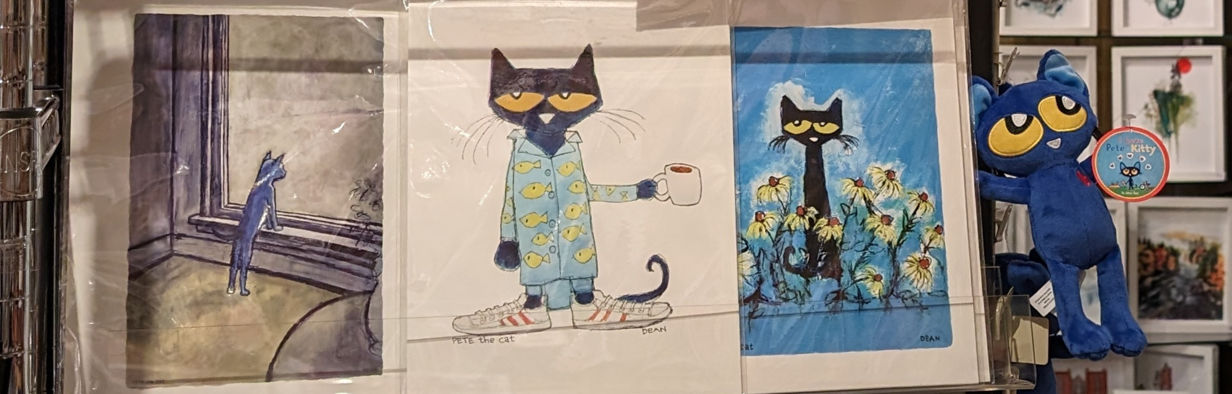 Pete the Cat prints on a clear shelf