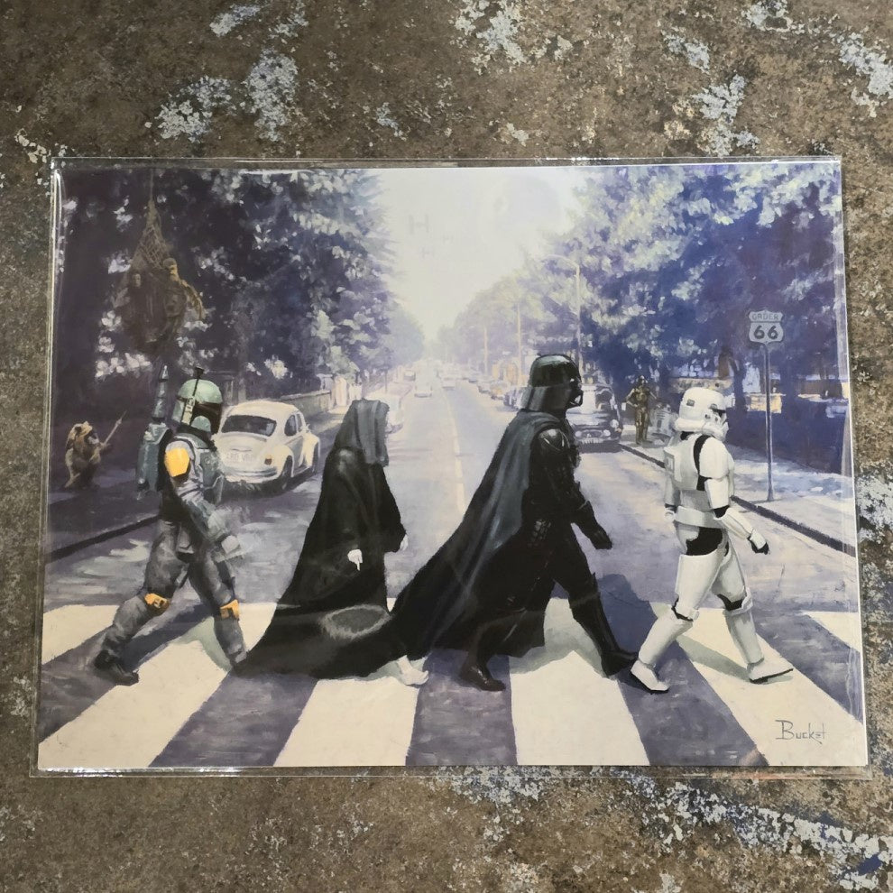 A print depicting four Star Wars characters including Darth Vader and a Storm Trouper crossing the street in the style of the iconic Beatles photograph.