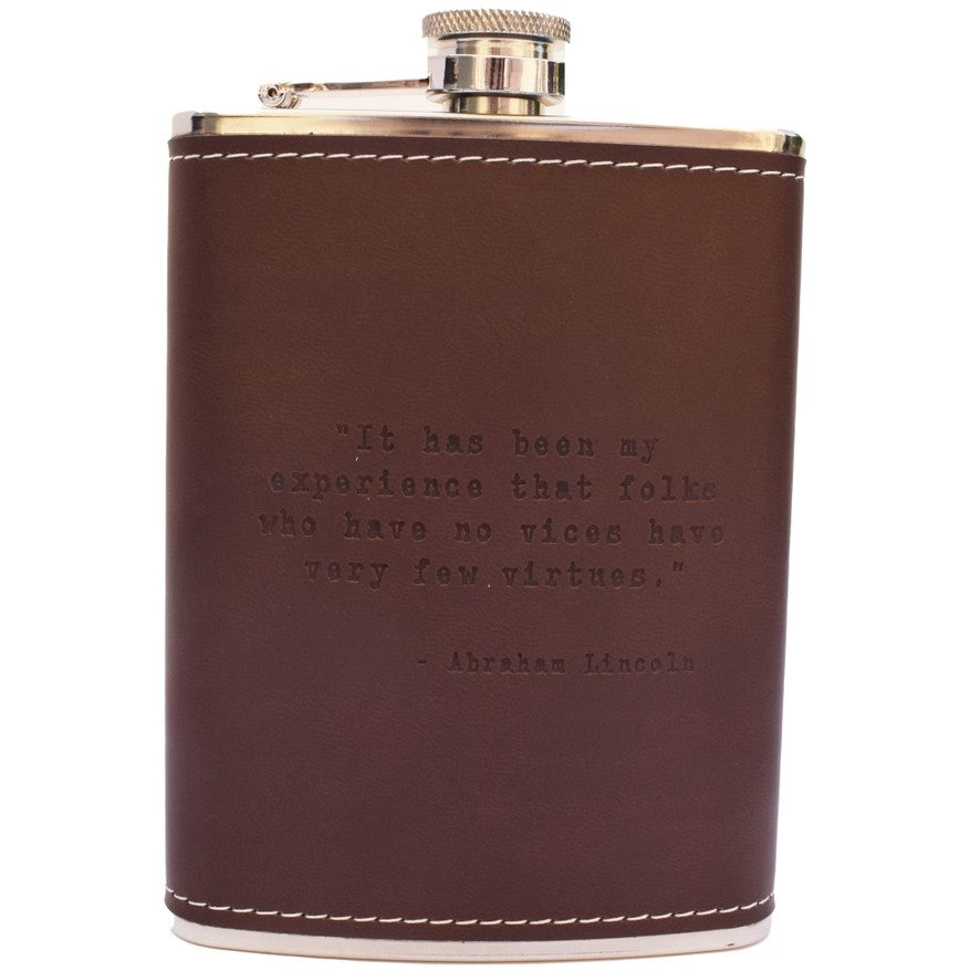 A metal and leather flask imprinted with the Abraham Lincoln quote: "It has been my experience that folks who have no vices have very few virtues."