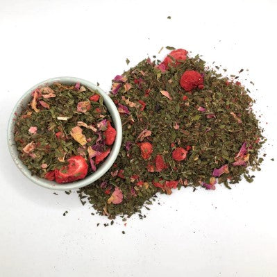 unbagged loose leaf tea on table and bowl with strawberries