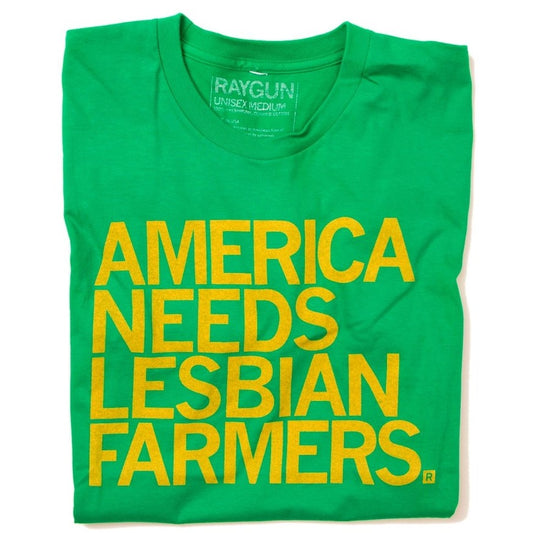 Green tee shirt with bright yellow text that reads "America Needs Lesbian Farmers."