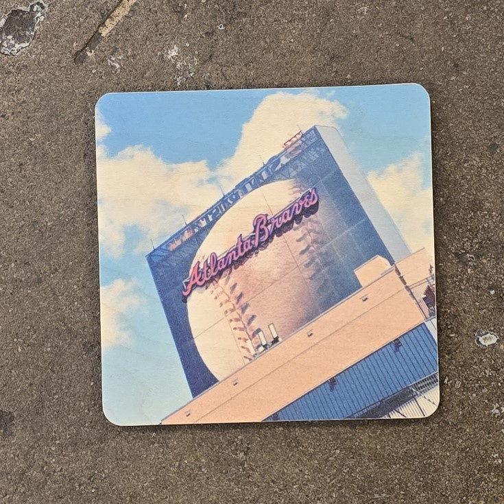 A coaster featuring a photograph of the Atlanta Braves stadium projection